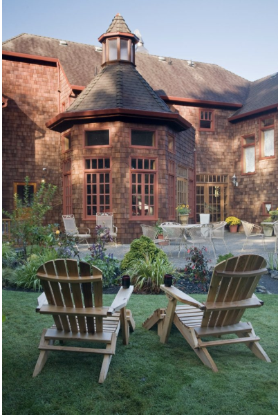 Quaint brick courtyard and Adirondack chairs at Arch Cape Inn, a peaceful retreat for intimate coastal weddings.